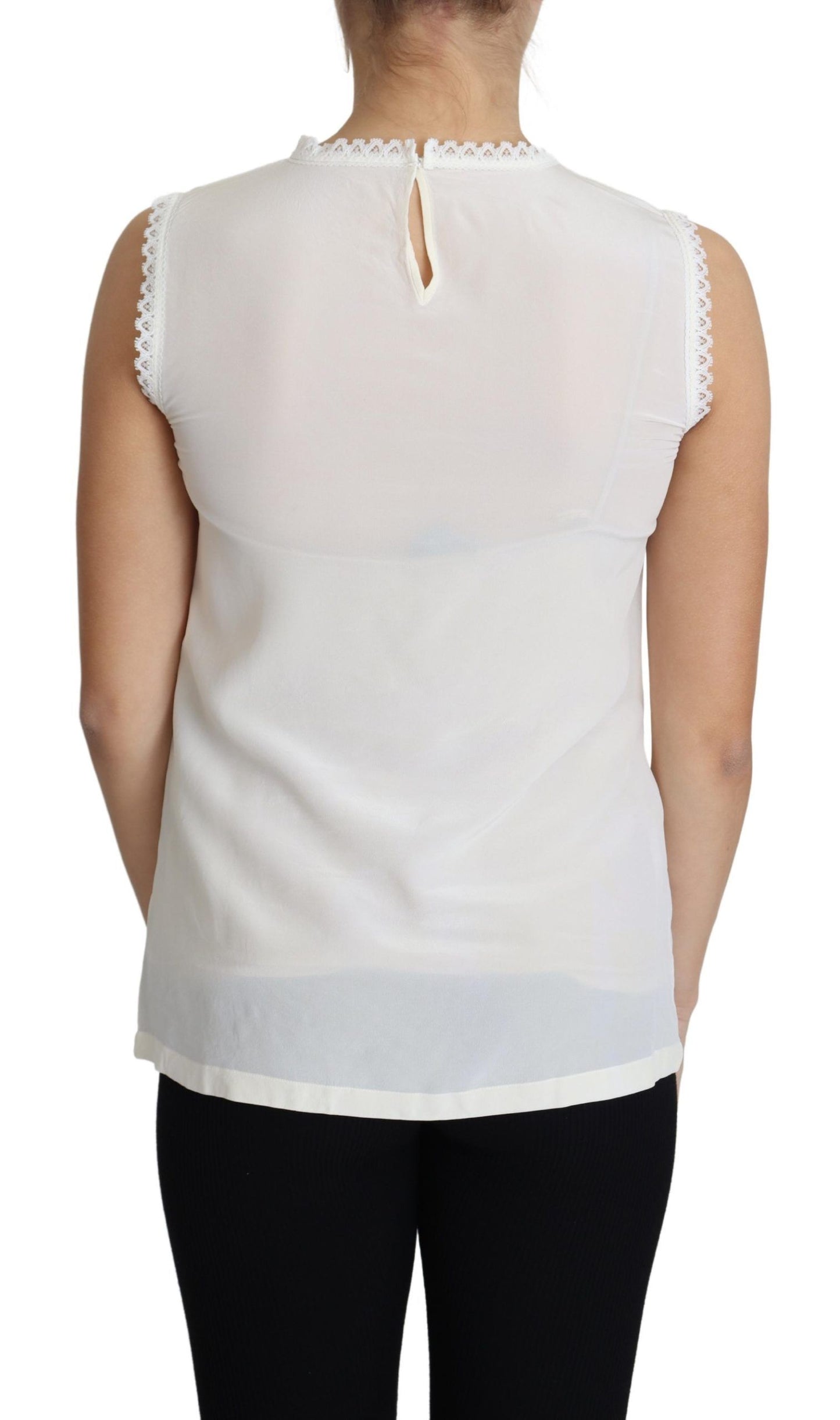 Blouse blanche Dolce & Gabbana en soie, avec empiècements en dentelle, sans manches.