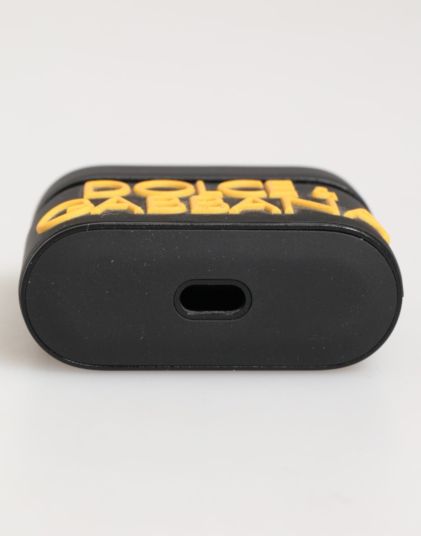 Étui Airpods en caoutchouc noir et jaune avec logo embossé de Dolce & Gabbana