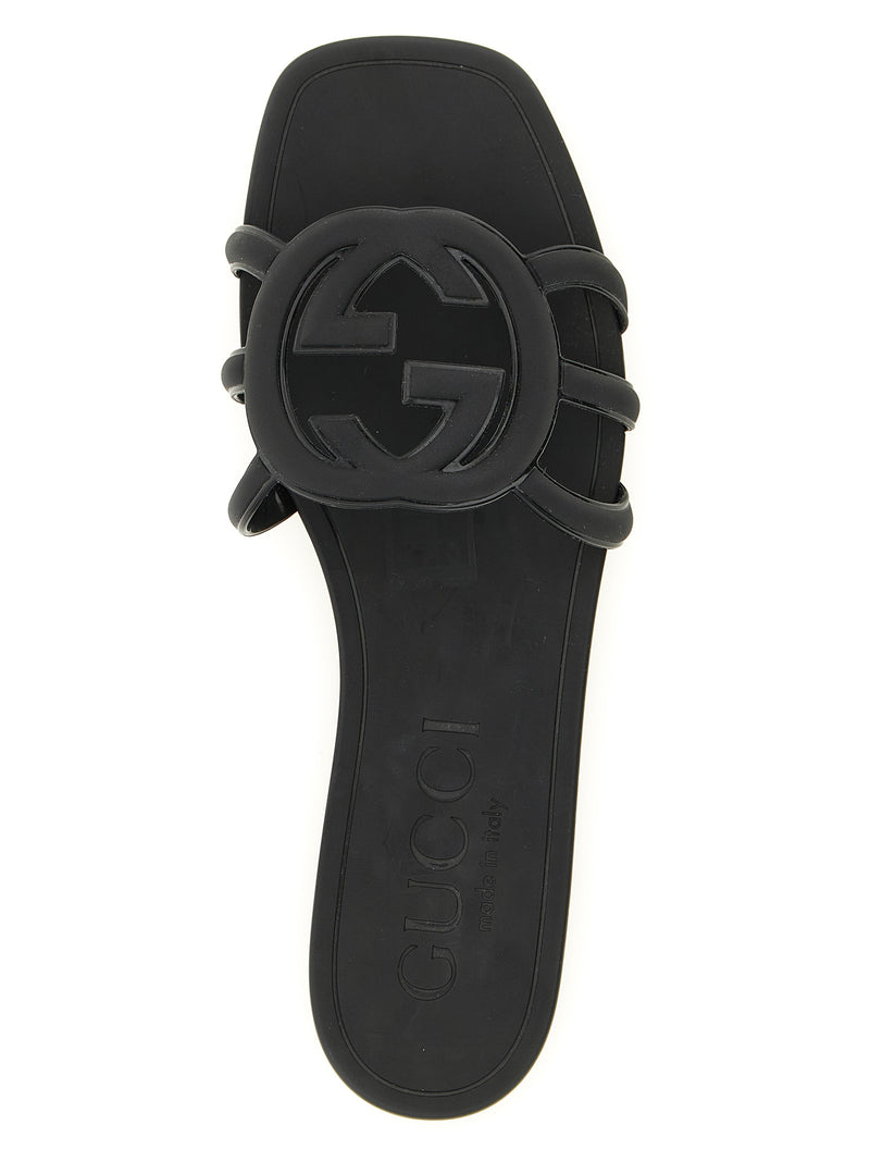 Mules en caoutchouc noires Gucci