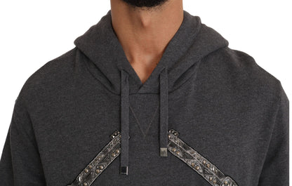 Pull gris à capuche Dolce & Gabbana avec cœur rouge en cristal et motif pistolet.