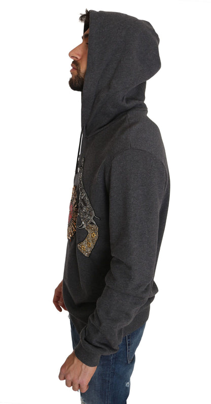 Pull gris à capuche Dolce & Gabbana avec cœur rouge en cristal et motif pistolet.
