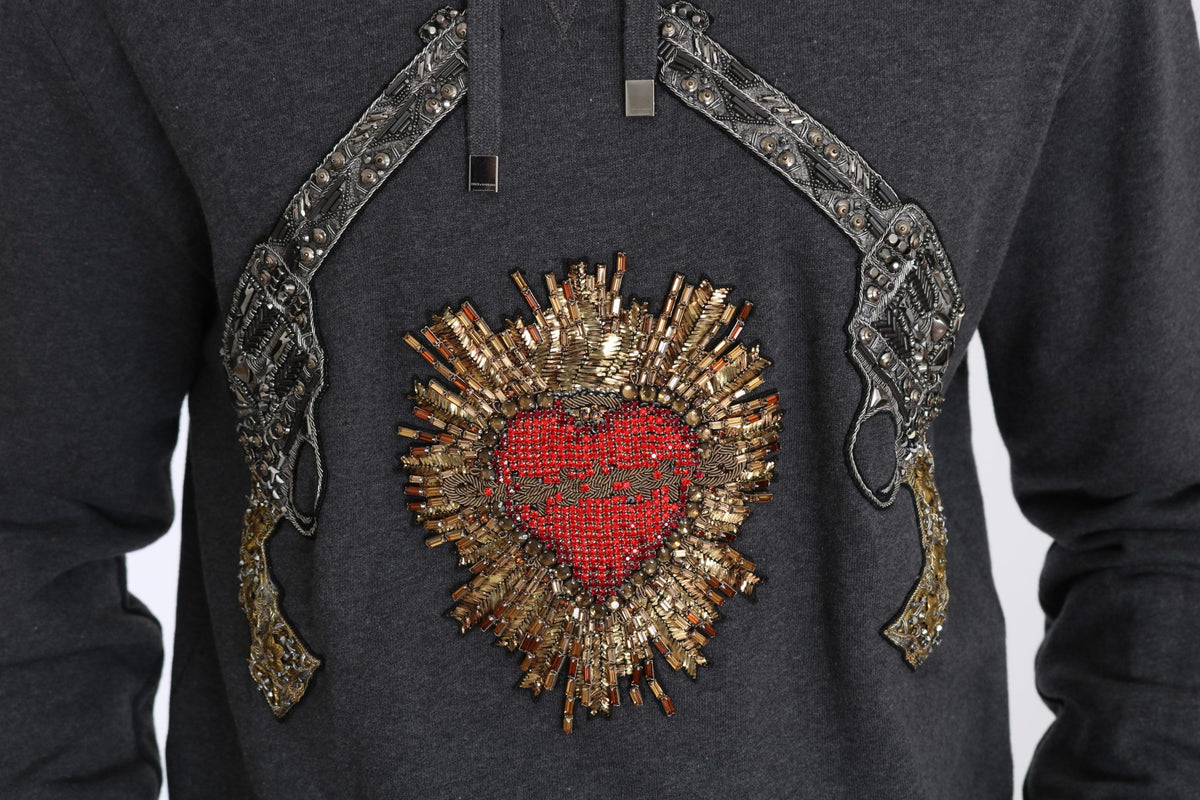 Pull gris à capuche Dolce &amp; Gabbana avec cœur rouge en cristal et motif pistolet.