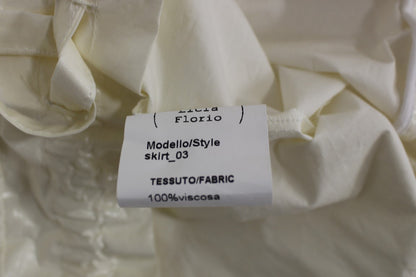 Jupe Licia Florio blanche, taille haute, extensible, avec bretelles, au-dessus du genou
