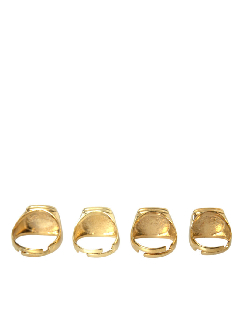 Dolce & Gabbana Lot de 4 bagues en laiton doré et émail KING