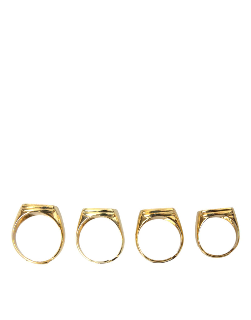Dolce & Gabbana Lot de 4 bagues en laiton doré et émail KING