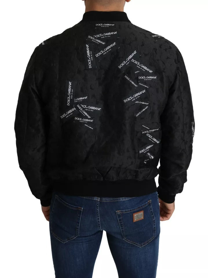 Veste bomber à fermeture éclair intégrale en brocart noir avec logo Dolce & Gabbana.