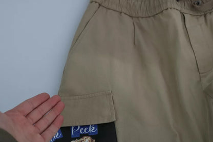 Dolce & Gabbana beige cargo broek met pin-up print