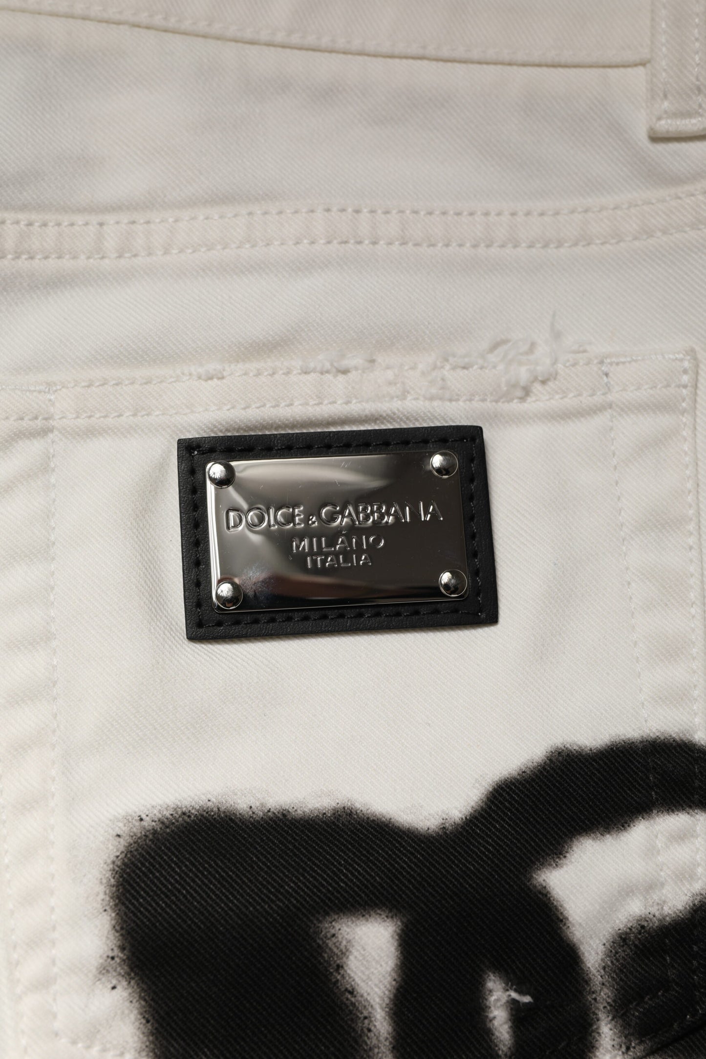 Jeans skinny en jean blanc délavé et dépareillé avec graffitis de Dolce & Gabbana
