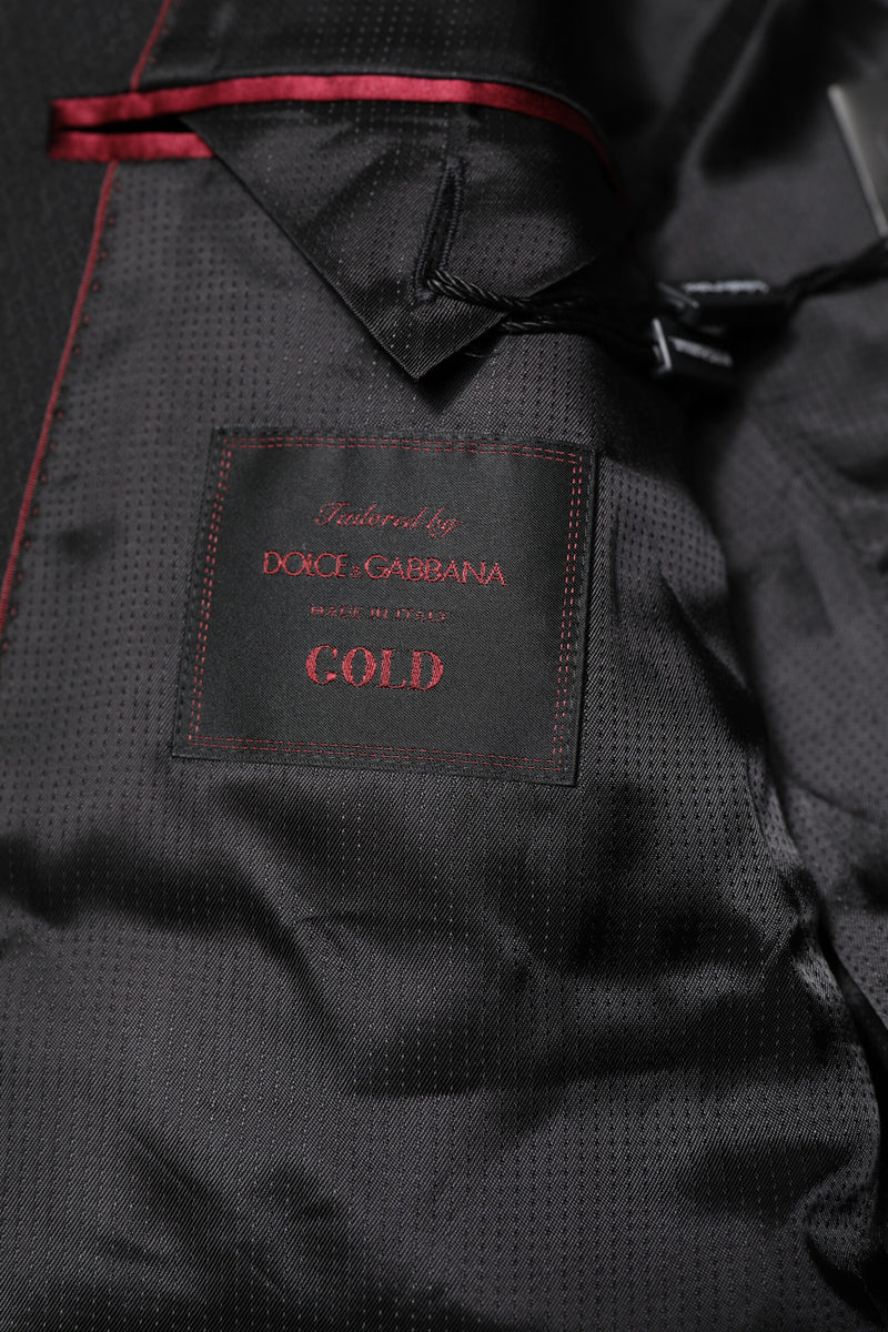 Dolce &amp; Gabbana, veste-blazer noire à simple boutonnage, ornée de détails dorés.