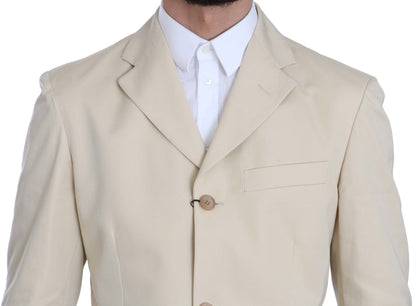Costume deux pièces en coton beige uni, à trois boutons, de Romeo Gigli.