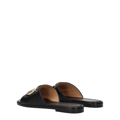 Slippers/sandalen van zwart en wit leder