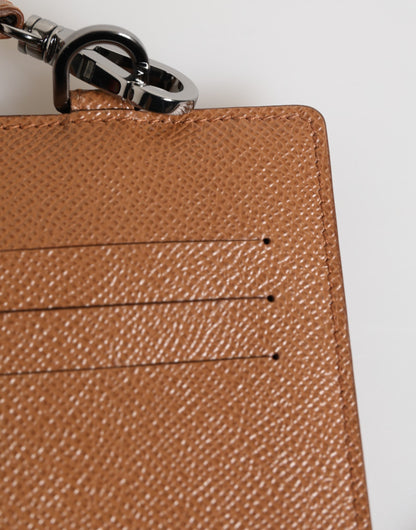 Porte-cartes homme Dolce & Gabbana en cuir marron foncé avec cordon et logo.