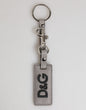 Porte-clés homme Dolce &amp; Gabbana en cuir gris avec anneau métallique et logo.