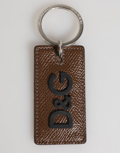 Porte-clés Dolce &amp; Gabbana en cuir marron foncé avec anneau métallique et logo.