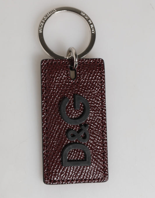 Porte-clés homme Dolce &amp; Gabbana en cuir marron foncé avec logo et anneau en métal.