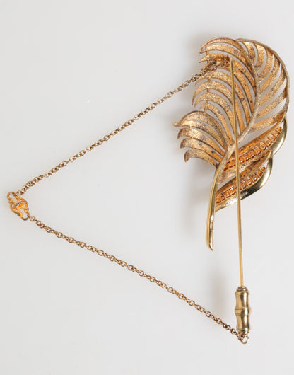 Broche Dolce &amp; Gabbana en forme de feuille, plaquée or, avec chaîne en cristal et argent sterling 925.
