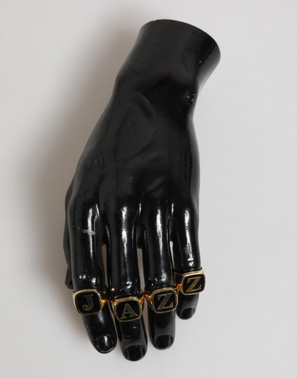 Ensemble de 4 bagues réglables Dolce &amp; Gabbana en laiton doré, avec inscription JAZZ.