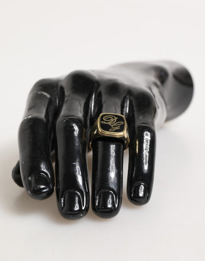 Bague signet DG en laiton doré et émail, logo ajustable de Dolce & Gabbana.