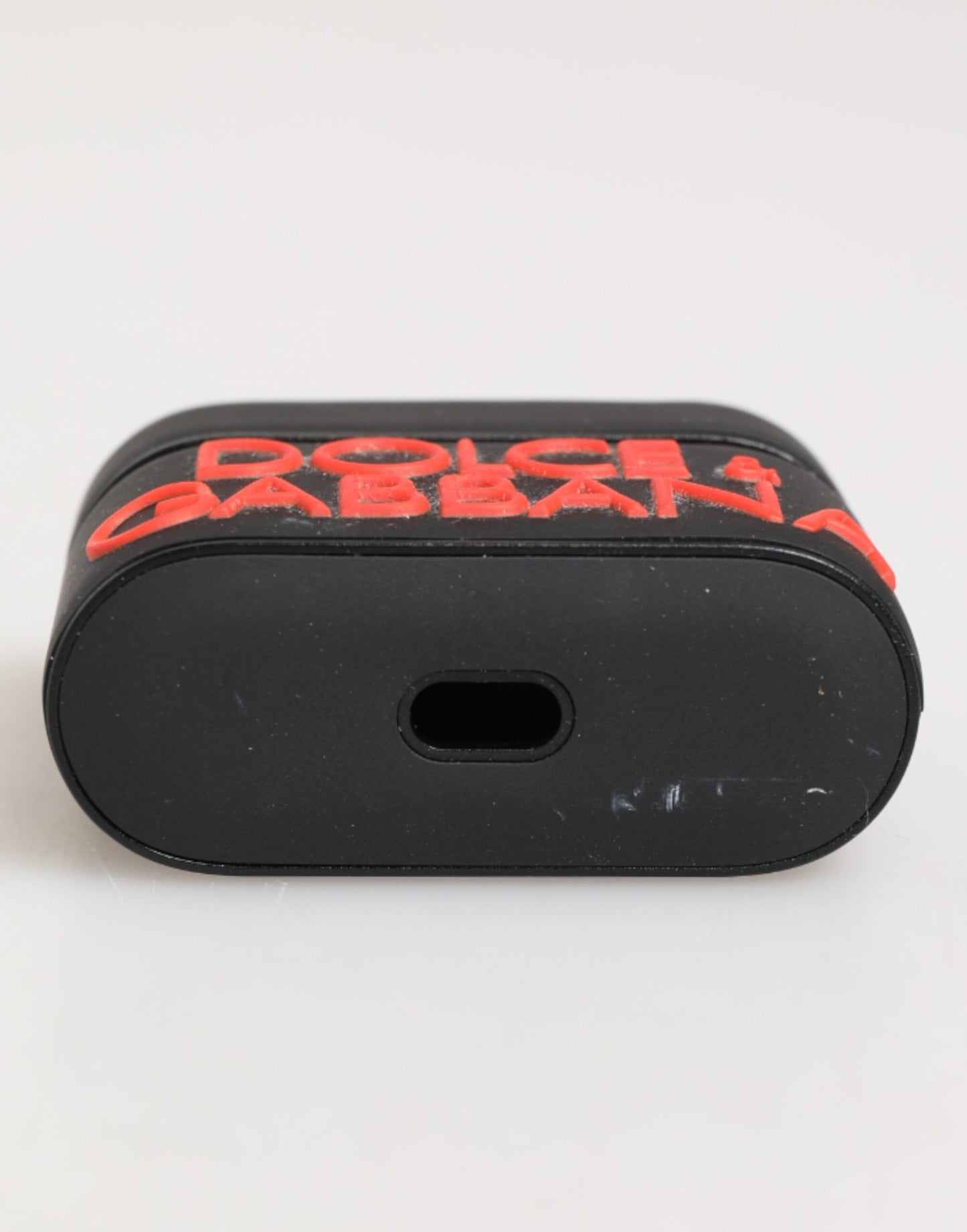 Étui Airpods en caoutchouc noir et orange avec logo en relief Dolce & Gabbana
