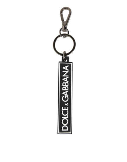 Porte-clés homme Dolce & Gabbana en caoutchouc noir et blanc avec logo DG argenté.