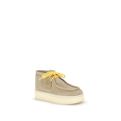 Bottes plates en cuir Miu Miu