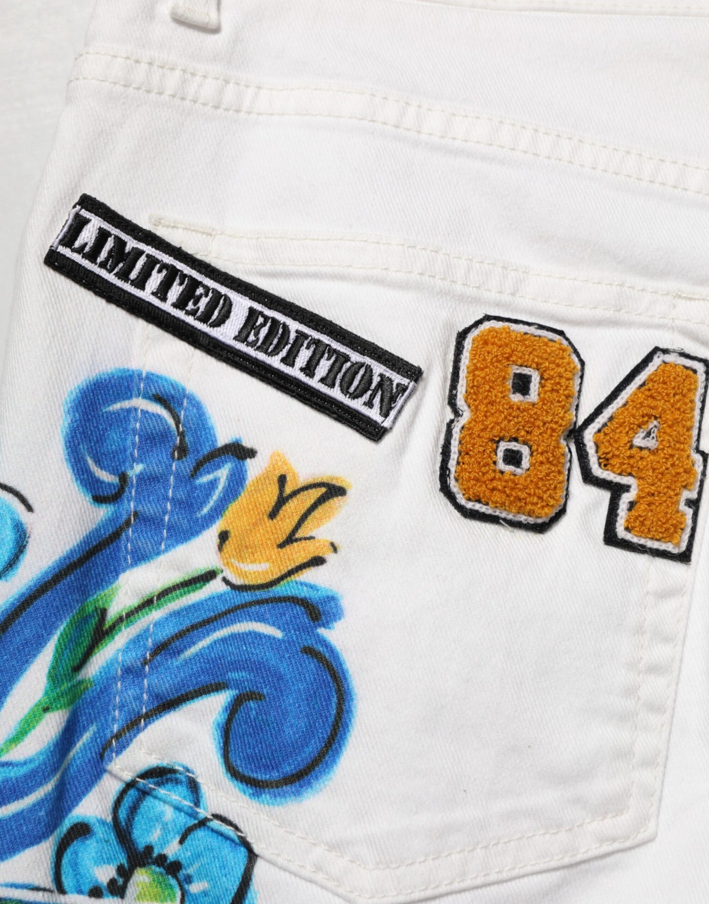 Jeans skinny en jean doré à imprimé graffiti blanc Dolce &amp; Gabbana